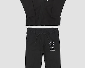 May include: Black martial arts uniform set, featuring a jacket and pants. The jacket has the word "RVCA" in white on the front and the brand name on the back. The pants have a drawstring waist and the "RVCA" logo in white. The uniform is displayed on a light gray background.
