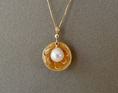 White pearl in golden bro...