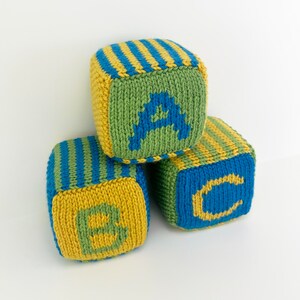 set of knit blocks with letters a, b and c in green, yellow and blue