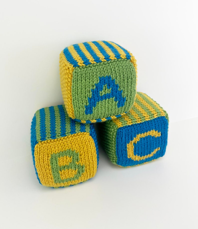 set of knit blocks with letters a, b and c in green, yellow and blue