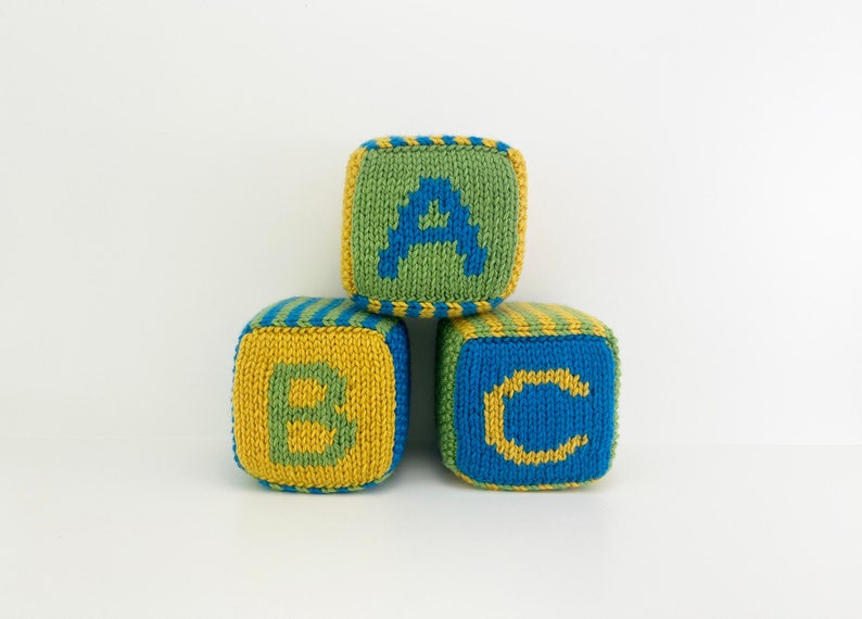 set of knit blocks with letters a, b and c in green, yellow and blue