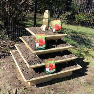 How to build a 4 ft. pyramid strawberry planter. Downloadable plans. Planter filled with dirt, ready for planting.