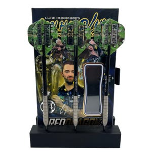 May include: A set of darts with green and black flights, presented in a black stand. The flights have a circuit board design and the word "PENTATHLON". The packaging behind the darts features a portrait of Luke Humphries and the words "RED DRAGON".