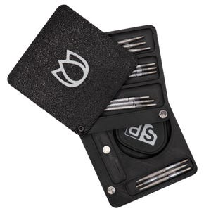 May include: Black dart case with a white tulip logo on the cover. The case is open, revealing several silver darts in organised compartments. The case also has a small pouch with the letters "SP" in white.