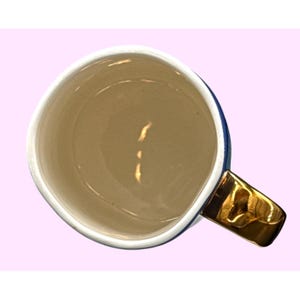 May include: A white ceramic mug with a black handle and the text "But First, Coffee" in a handwritten style. The mug is on a white surface. The mug is approximately 4 inches tall.