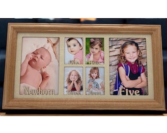 May include: A wooden picture frame with eight openings for photos. The frame has a light brown finish and the openings are labeled with the words "Newborn", "One", "Two", "Three", "Four", and "Five".