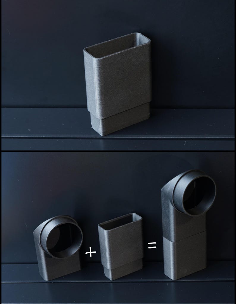 May include: A dark gray, rectangular object with a smaller rectangular base. The image shows how the object can be combined with a curved, cylindrical piece to form a right-angle connector. The objects are on a dark surface.