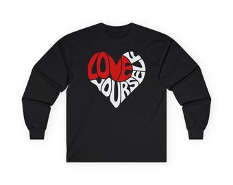 May include: Black long-sleeve shirt featuring a heart-shaped design. The heart is divided into red and white sections, with the words "LOVE YOURSELF" in a bold, stylized font. The shirt is made of a soft, comfortable material.
