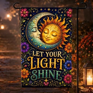 May include: A rectangular garden flag featuring a crescent moon and a sun with faces, surrounded by colorful flowers and vines on a dark blue background. The text LET YOUR LIGHT SHINE is printed in large, decorative yellow and teal lettering.