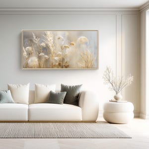 May include: A rectangular framed wall art piece featuring a soft-focus, ethereal depiction of dried grasses and wildflowers in shades of cream, beige, and pale gold, set against a muted, light-toned background with a subtle, painterly texture.