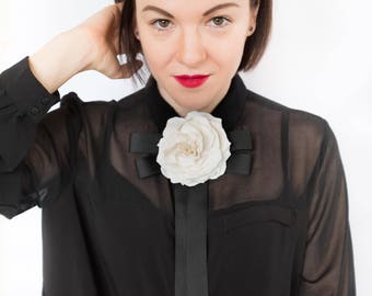 White Ivory flower brooch with a black bow made from ribbon, bow tie brooch with flower