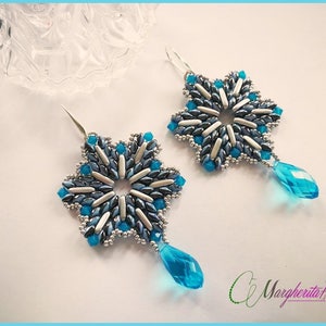 May include: A pair of snowflake-shaped earrings with blue and silver beads, each earring has a teardrop-shaped blue crystal dangling from the bottom.
