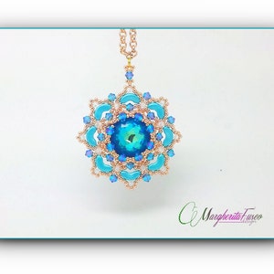 May include: A gold chain necklace with a blue and gold beaded pendant featuring a large blue crystal in the centre. The pendant is shaped like a flower with multiple layers of beads.