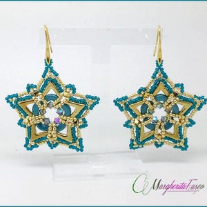 Può includere: Un paio di orecchini a forma di stella dorati e blu-verde con un cristallo al centro. Gli orecchini sono perlati e hanno un design pendente.