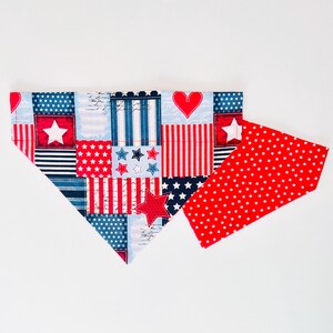 May include: A patriotic dog bandana with a patchwork design featuring red, white, and blue patterns. The bandana includes stars, stripes, and a heart, with a separate red piece covered in white stars.