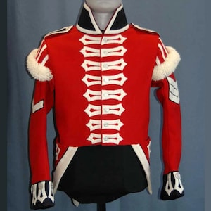 May include: A bright red military-style jacket featuring white braided cord detailing across the front, a high black collar with white trim, white fur-like epaulettes on the shoulders, and white chevron accents on the sleeves and cuffs.
