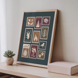 May include: Framed art print featuring a collection of postage stamp designs with fantasy-themed illustrations. The stamps are in shades of beige, burgundy, and brown, set against a dark teal background. The wooden frame adds a natural touch to the artwork.