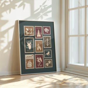 May include: Framed print featuring a collection of postage stamp designs. The stamps, in shades of brown, burgundy, and teal, depict various illustrations including a deer, dragon, castle, and ship. The frame is white, and the background is a dark teal.