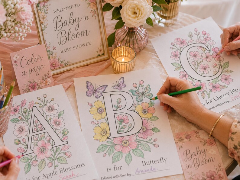 Baby in Bloom baby shower activity with guests coloring floral alphabet pages for Baby’s First ABC Book keepsake. Printable baby shower game featuring blush pink flowers, butterfly coloring pages, and personalized ABC book pages guests color and sign for baby. Elegant floral baby shower decor and interactive keepsake activity for a girl baby shower.