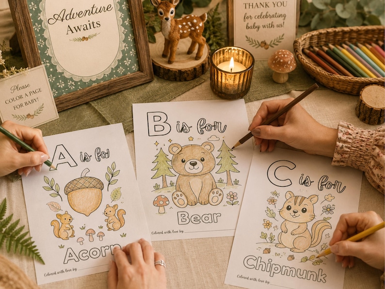 Woodland baby shower ABC book activity printable featuring guests coloring alphabet pages at a cozy baby shower table. Includes woodland animal coloring sheets, baby shower keepsake activity, printable ABC book game, forest theme baby shower decor, and gender neutral baby shower activity with colored pencils and rustic woodland decorations.