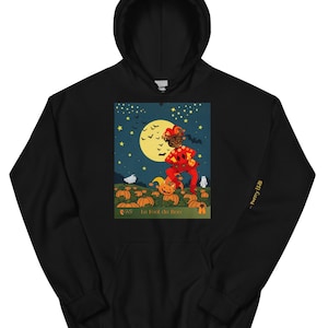 May include: Black hooded sweatshirt featuring a colorful graphic of a jester in a pumpkin patch under a full moon. The graphic includes the text "AS La Fool du Pere" and "- Perry Hall" on the sleeve. The design has a Halloween theme.