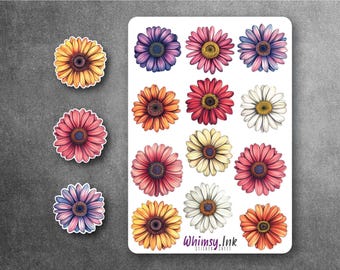 May include: A sticker sheet featuring twelve individual daisy-like flower stickers in various colors including yellow, pink, purple, orange, and white. Three additional loose flower stickers are placed to the left. The text Whimsy.Ink is printed at the bottom.
