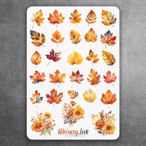 May include: A sticker sheet featuring a collection of watercolor-style autumn leaves in shades of orange, red, yellow, and brown, along with three floral bouquets at the bottom. The text Whimsy.Ink is printed in orange at the bottom center.
