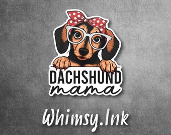 May include: A sticker featuring a black and tan dachshund wearing white-rimmed glasses and a red polka-dot headscarf. The dog rests its paws on a sign that reads DACHSHUND mama in black text. Below the sticker, the text Whimsy.Ink is visible.