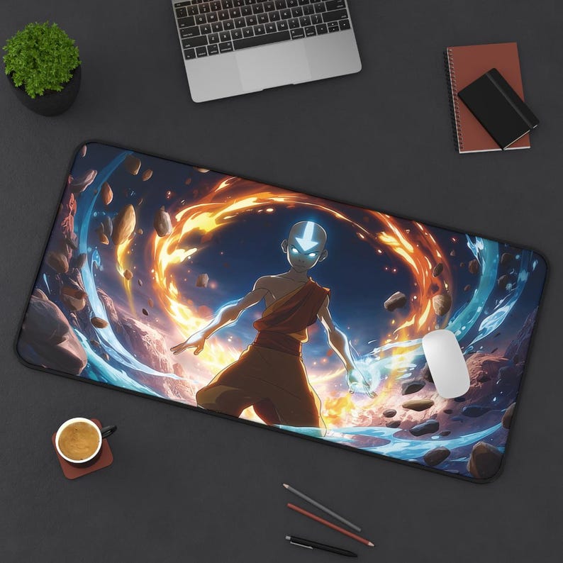 May include: Rectangular mouse mat with a colourful illustration of a character amidst fiery and aquatic elements. The character has a blue arrow on their forehead. A white mouse and other office items are also visible. The mat is designed for computer use.