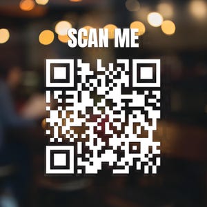May include: A white QR code with the text "SCAN ME" in a bold font. The background is blurred with warm, out-of-focus lights. The QR code is a square pattern of black and white squares, designed for digital scanning and information access.