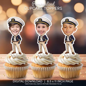 May include: Three cupcakes topped with personalized sailor-themed cupcake toppers. Each topper features a cartoon illustration of a child in a sailor uniform and hat. The cupcakes have white frosting and are on a wooden surface. The text "Personalized CUPCAKE TOPPERS" is at the top.