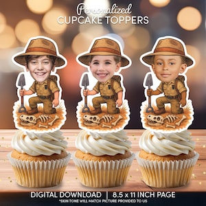 May include: Three cupcakes topped with personalized cartoon images of children dressed as archaeologists, holding shovels. The toppers are on a bed of grass with dinosaur bones. The cupcakes have white frosting. Text at the top reads "Personalized CUPCAKE TOPPERS".