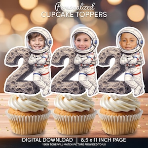 May include: Three cupcakes topped with personalized astronaut-themed cupcake toppers. Each topper features a child's face in an astronaut suit, leaning against a number 2. The text "Personalized CUPCAKE TOPPERS" is at the top. The bottom text reads "DIGITAL DOWNLOAD | 8.5 x 11 INCH PAGE".