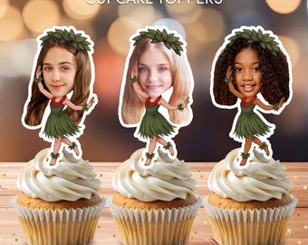 May include: Three cupcakes topped with personalized cartoon cutouts of girls in hula outfits. The toppers have the girls' faces and are wearing green skirts, leaf crowns, and leis. The text "Personalized CUPCAKE TOPPERS" is at the top.