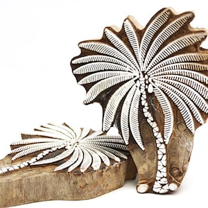 May include: Two wooden palm tree stamps with white raised designs. The stamps are carved from wood and are ready to be used for printing.