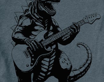 May include: A black and white illustration of a dinosaur playing an electric guitar. The dinosaur has sharp teeth and claws, and is wearing a rock and roll pose. The guitar has a black body and a white pickguard.