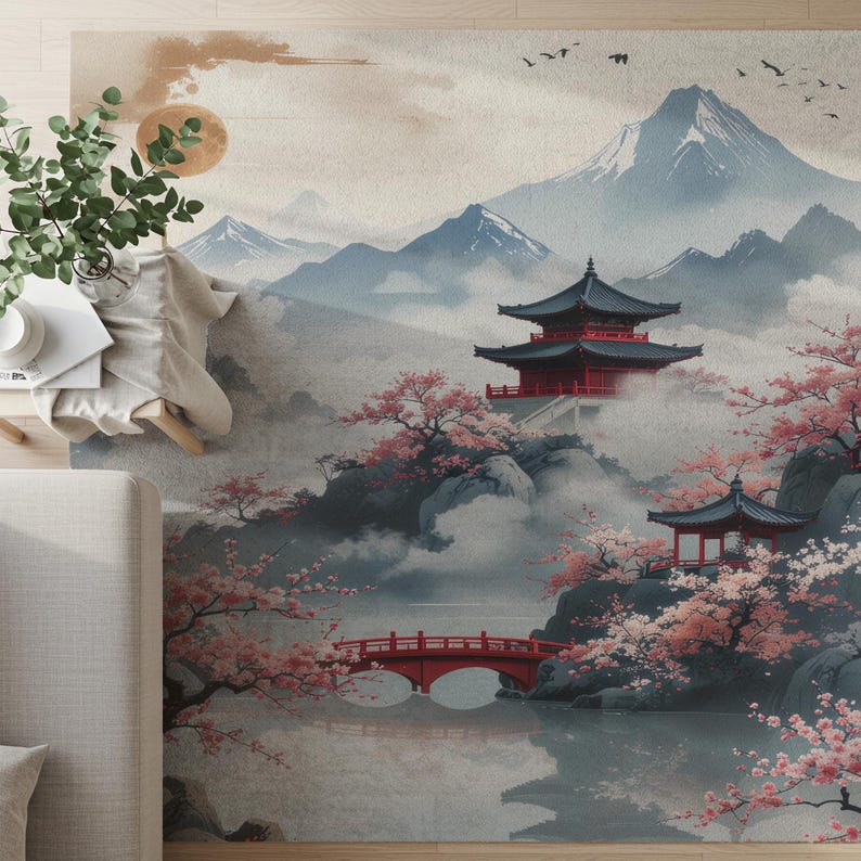 May include: A rug featuring a Japanese landscape scene with a red pagoda, bridge, and cherry blossoms. The design includes mountains, a lake, and a soft color palette of blues, reds, and pinks.
