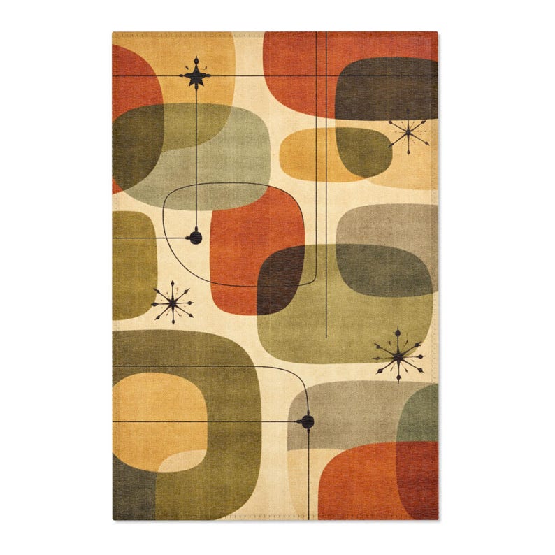May include: A rectangular, mid-century modern style rug featuring an abstract design. The rug has a cream-colored background with overlapping, rounded shapes in shades of orange, green, and brown. Black lines and starburst accents complete the retro aesthetic.