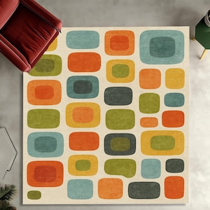 May include: A rectangular area rug featuring a repeating pattern of rounded rectangular shapes in shades of orange, yellow, olive green, teal, and dark grey on a cream-coloured background. The design consists of nested and solid colour blocks.