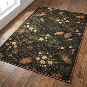 May include: Rectangular rug with a dark green backdrop, patterned with leaves, small white flowers, and brown leaves. The rug has a beige border and is placed on a wooden floor.