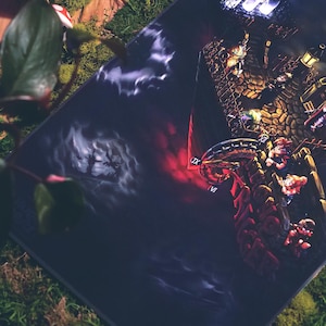 May include: A dark, fantasy-themed art print featuring a large, intricate, golden structure with multiple figures standing on it. The structure is surrounded by dark clouds and a red glow. The print has a dramatic and atmospheric feel.