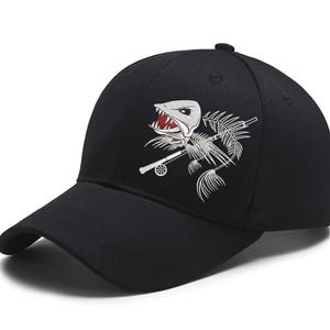 May include: Black baseball cap featuring a white and red embroidered design of a fish skeleton with a fishing rod. The cap has a curved brim and a button on top. A stylish accessory for fishing enthusiasts.