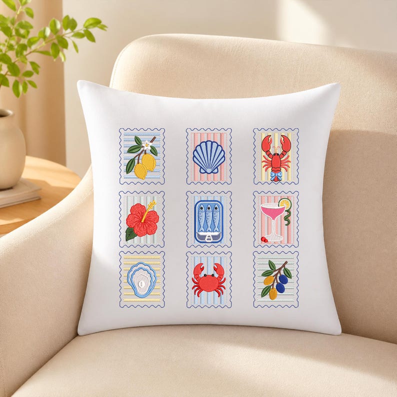 May include: A white square throw pillow featuring a grid of nine postage stamp-style illustrations. The designs include lemons, a seashell, a lobster, a hibiscus flower, a tin of sardines, a cocktail, an oyster, a crab, and olives on a branch.