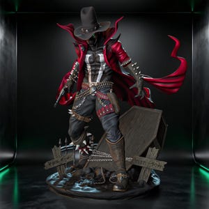 May include: A detailed figurine of the Spawn character, standing on a base with a tombstone. The figure wears a black hat, red cape, and black outfit with white accents. The figure is holding a gun.