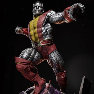May include: A detailed statue of Colossus, a superhero, in a dynamic pose. The figure is predominantly silver with red and yellow accents. The statue is standing on a base of debris, with a stern expression.