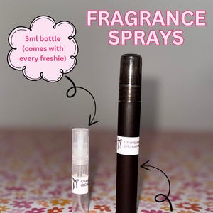 May include: Image of fragrance sprays. A small, clear 3ml bottle and a larger, dark brown 10ml bottle are displayed. The text "FRAGRANCE SPRAYS" is at the top. The 3ml bottle is labeled "3ml bottle (comes with every freshie)".