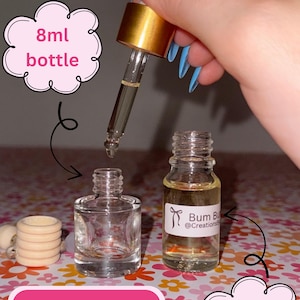 May include: A diffuser bundle featuring two small glass bottles, one 8ml and one 10ml, with a dropper. One bottle has a label that reads "Bum Bu @Creations". The image also includes a pink sign that says "DIFFUSER BUNDLE".