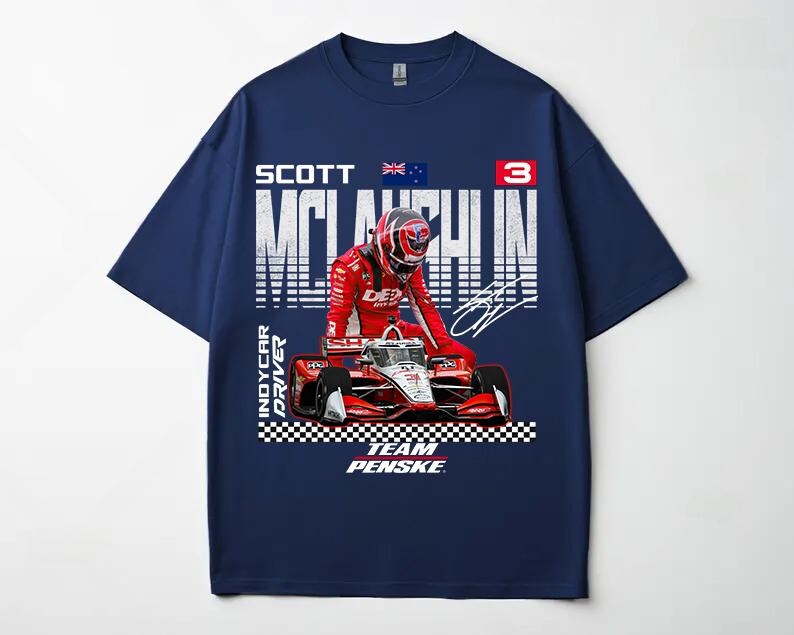 May include: Navy blue t-shirt featuring a graphic of a race car and driver in a red racing suit. The shirt includes the text "SCOTT McLAUGHLIN" and "TEAM PENSKE". The Australian flag is also visible.
