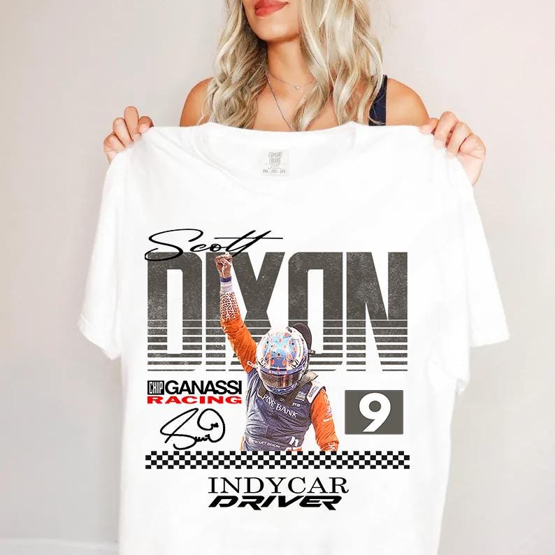 May include: White t-shirt featuring a graphic of Scott Dixon, an IndyCar driver, with the text "Scott Dixon" above a large "DIXON" and the number "9". The shirt also includes the text "Chip Ganassi Racing" and "IndyCar Driver".
