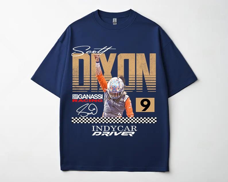 May include: Navy blue t-shirt featuring a graphic of a race car driver with the name "Scott Dixon" and the word "Dixon" in large, distressed gold letters. The number "9" is also visible. The shirt includes the text "Indycar Driver".